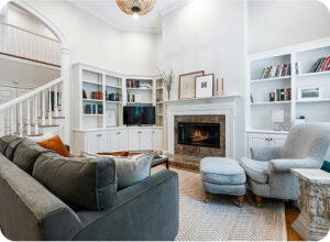 Elegant living room with fireplace, built-in shelves, and cozy seating area.