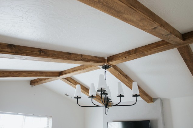 Custom box beams installed on a ceiling with chandelier.