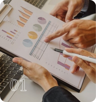 close-up of hands pointing at business charts and graphs on a clipboard