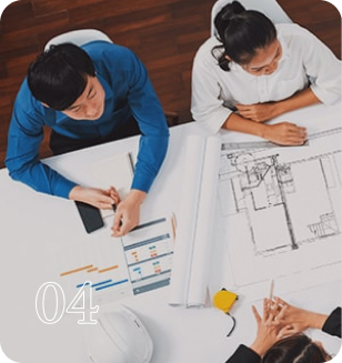 top-down view of three people discussing over architectural plans