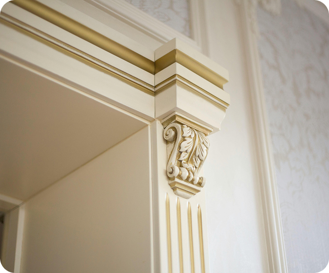 A close-up of an intricately designed door frame with ornate details and golden accents.