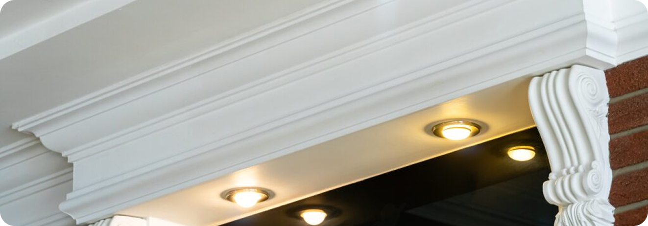 A close-up of decorative molding with recessed lighting, highlighting the architectural detail.